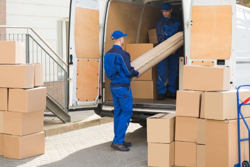 Removal van and moving boxes in a Leamouth residential area