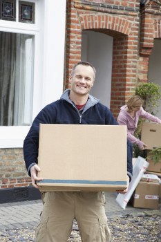 Man with van loading items into a moving vehicle