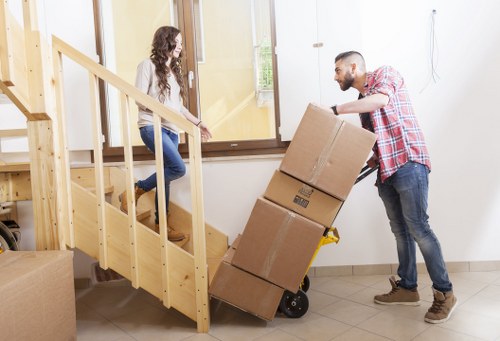 Professional movers carrying furniture in a modern apartment building